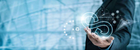 Businessman hold circular economy icon. Sustainable strategy approach to eliminate waste and...
