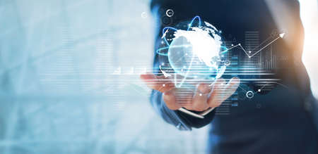 Businessman holding circle global network connection and data exchanges worldwide on work place background, business network communication and technology conceptの写真素材