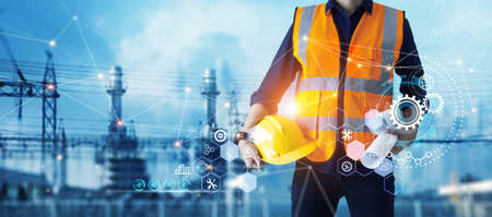 Male industrial, Electrical engineer with helmet and blueprints in hands checking, maintenance, and...