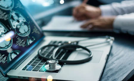 Medicine doctor research and analysis. Diagnose checking brain testing result patient with screen interface on laptop and stethoscope, Futuristic healthcare, Medical technology and innovative conceptの写真素材