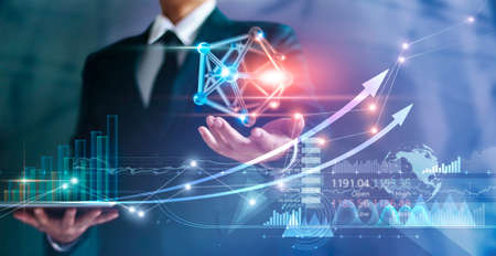 Businessman holding symbol network connection and graph growth of business, Economy and finance on global business, Social media and communication networking.の写真素材