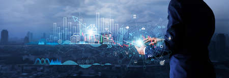 Businessman using tablet analyzing sales data and economic growth graph chart on global network. Business strategy. Digital marketing. Financial and banking.の写真素材