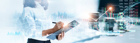Business Woman writing report and analyzing sales data of economic growth graph chart and investment. Business strategy. Digital marketing. Cryptocurrency. Banking. Finance and stock market.の写真素材