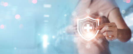 Woman hold virtual medical network connection icons. Covid-19 pandemic develop people awareness and spread attention on their healthcare, rising growth in hospital and health insurance business.の写真素材