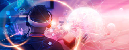 Metaverse Technology concepts. Teenager play VR virtual reality goggle and experiences of metaverse virtual world. Visualization and simulation, Gamer, 3D, AR, VR, Innovation of futuristic.の写真素材