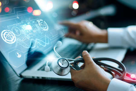 Medicine doctor analysis and diagnosis checking health of patient online and testing result with modern virtual interface on laptop with stethoscope in hand, Online Medical global network concept.の写真素材