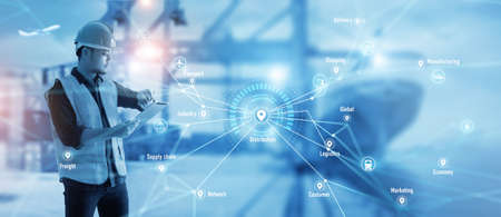 Worker using tablet on logistic network distribution and smart transportation on networking intelligent logistics container cargo ship, Logistic import export and industry. Blue tone.の写真素材