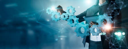 Businesswoman drawing connect pieces of gears wheel to success on network background, Development, Teamwork and partnership  conceptの写真素材