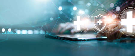 Businessman touch virtual medical network on tablet. Covid-19 pandemic develop people awareness and spread attention on their healthcare, rising growth in hospital and health insurance business.の写真素材
