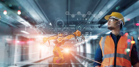 Technical Industrial Engineer working and control robotics with monitoring system software and industry network connection on modern interface. AI, Artificial Intelligence, Automation robot arm.の写真素材