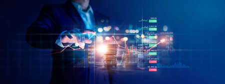 Businessman touching graph growth and analyzing finance sales data with economic growth chart of financial by investment in valuable asset, Economy, Banking and stock market.の写真素材