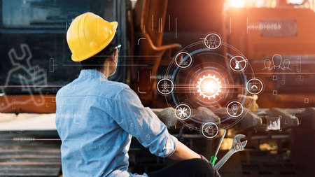 Industrial Engineer. Mechanical Engineering with tools maintenance of tractor and icon engineering on construction site.の写真素材