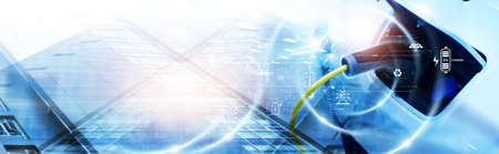 Energy EV car and clean energy. Futuristic hybrid vehicle charge battery electric with icon of clean energy on city background, Development on renewable energy, Sustainable eco energy, Blue tone.の写真素材