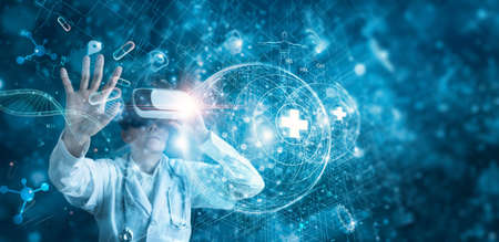 Medical technology concept. Doctor wearing virtual reality glasses to research. Checking data patient result with simulator interface on healthcare network, Innovation in science and medicine.の写真素材