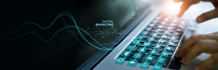 Businessman working with laptop and icon of digital marketing on virtual hologram, Global network connection, data exchange, digital technology and data science, Investment on global business.の写真素材