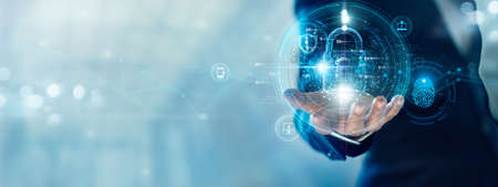 Cyber security and data protection. Businessman holding padlock protecting business data with virtual network connection. Innovation technology develop smart solution from digital attack.の写真素材