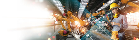 Engineer check and control welding robotics arm system for digital industry using software connected to internet network in intelligent factory industrial with monitoring system. Industry 4.0の写真素材