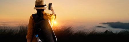 Woman traveler with backpack take a photo at amazing mountains on sunset, Tropical climate,...