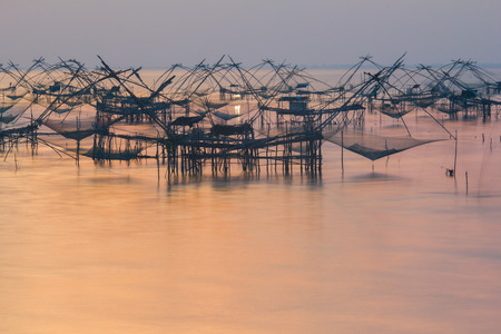 Beautiful reflection sunrise with fishing landscape in Thailand