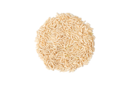 a heap of raw brown rice isolated on white background, top view, close upの写真素材