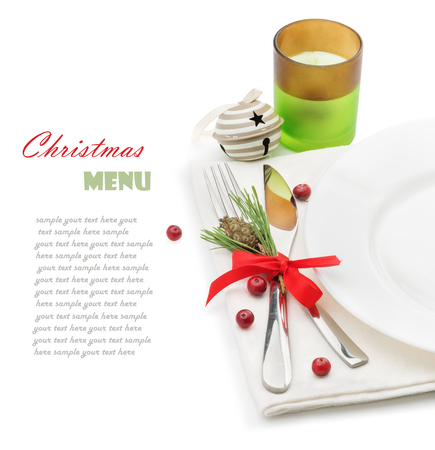 Christmas menu, plate fork and knife with decorations, ribbon, cranberry, candleholder, Christmas toy, space for text, isolated on white backgroundの写真素材