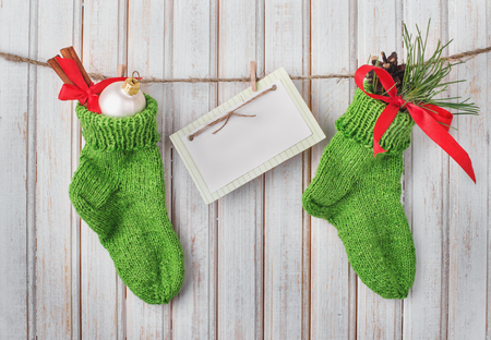 Christmas socks with decoration and sign for text on wooden backgroundの写真素材