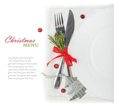 Christmas menu, plate fork and knife with decorations, ribbon, cranberry, space for text, isolated on white backgroundの写真素材