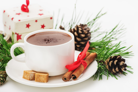 Greeting Card Merry Christmas, Happy New Year, the composition of the hot chocolate, gift, cinnamon, pine cones, pine twigs isolated on white backgroundの写真素材
