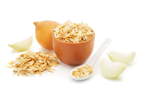 Dried onions in a white ceramic spoon, chopped fresh onion  isolated on white background closeupの写真素材