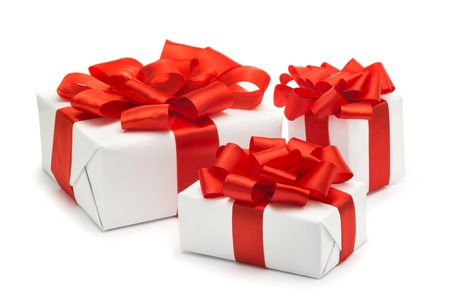 Gifts for Christmas, New Year, Valentine's Day, wrapped in white paper with red satin ribbon isolated on white backgroundの写真素材