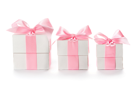 Gift  boxes with pink satin ribbon isolated on white background, congratulations on Women's Day, mum's day, Valentine's day, happy birthdayの写真素材