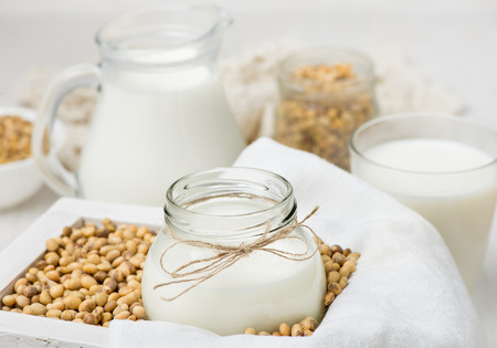 Soy milk in a glass jar and soybeansの写真素材