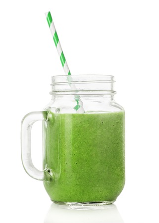 Green smoothies in a glass jar, a cocktail stick isolated on white background, healthy eating conceptの写真素材