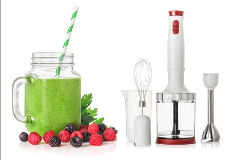 Green smoothies in a glass jar with raspberries and blackberries and Immersion blender isolated on white background, healthy eating conceptの写真素材