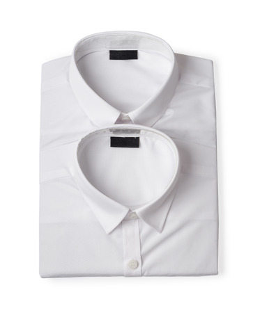 Two folded white new men's shirts close-up isolated on white backgroundの写真素材