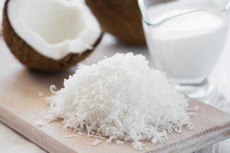 Coconut shavings on a chopping board closeupの写真素材
