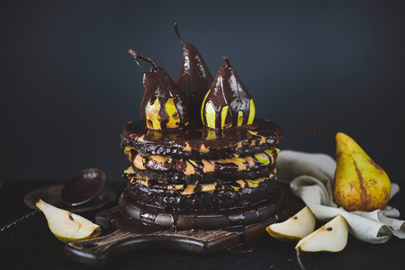 Chocolate cake with peanut cream and pearsの写真素材