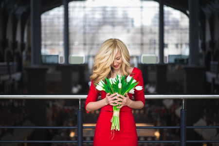 A portrait of a young beautiful woman with white flowers on the head. Spring fashion photoの写真素材