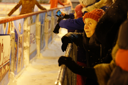 MOSCOW RUSSIA - 17 January 2016 - The face of an old woman who is watching people skating on the rink on the red Square. A sad sight, and memories of a bygone youthのeditorial素材
