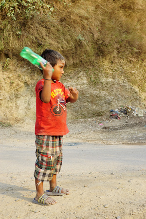 Pokhara, Nepal - April 24 2016: Serious Nepali boy playing on the roadのeditorial素材