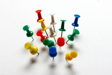 Paper and many color thumbtacks red, blue, green, yellow white