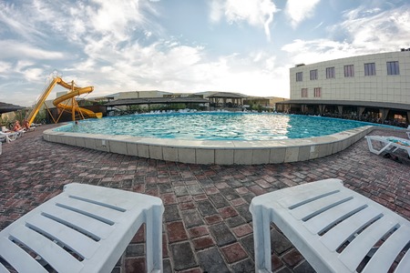 Kirillovka, Ukraine - August 28, 2016: Two sunbeds are near the poolのeditorial素材