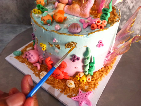 The final touch is using a brush in making birthday tartsの写真素材