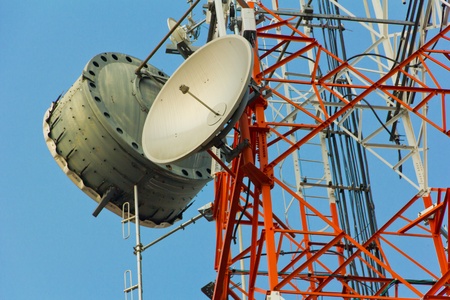 Telecommunication mast with antennas over a blue skyの写真素材