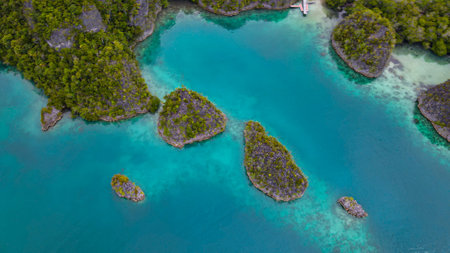 Aerial view of tropical islands, reefs, and lagoon in Raja Ampat, Indonesiaの写真素材