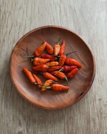 cayenne pepper in a bowl on a wooden backgroundの写真素材