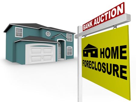 A home foreclosure sign stands in front of an attractive homeの写真素材