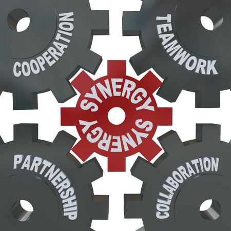Several cogwheel gears turning together, reading Synergy, Teamwork, Partnership, Collaboration and Cooperationの写真素材