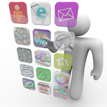 A man presses an app icon on a projected touch screen of appsの写真素材