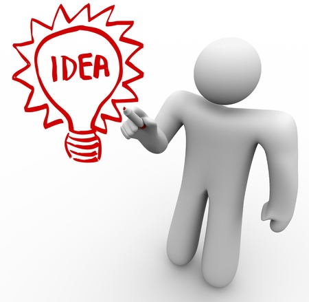 A person stands before a clear glass board and draws a light bulb with the word Idea in it as he brainstorms and thinks of an innovation that solves a problemの写真素材